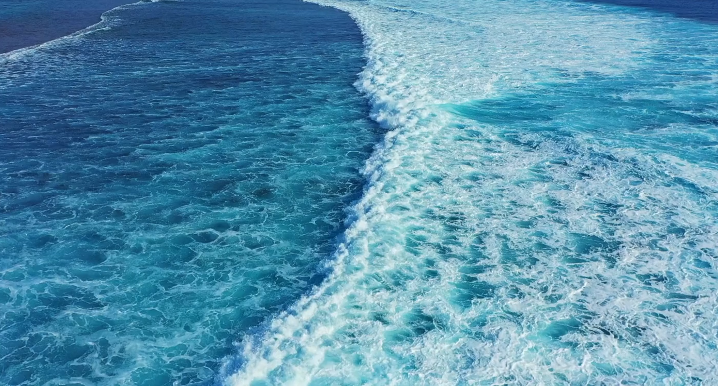 a bright blue ocean where sea salt is harvested